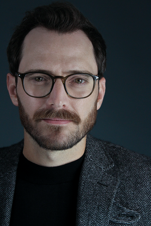 Headshot of Connor Marsico wearing glasses with a smirk